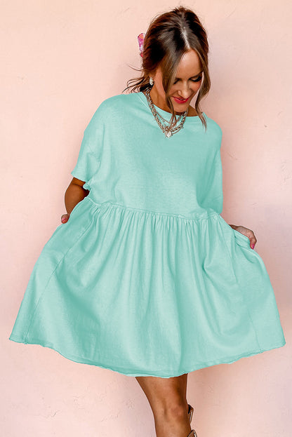 Robe babydoll unie couleur jade clair avec poches et bords effilochés