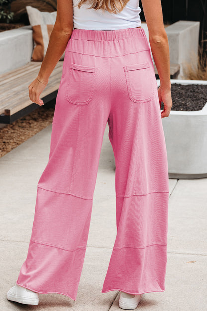 Pantalon cargo Bonbon à large jambe, taille élastique avec cordon de serrage, coutures apparentes et délavage minéral.