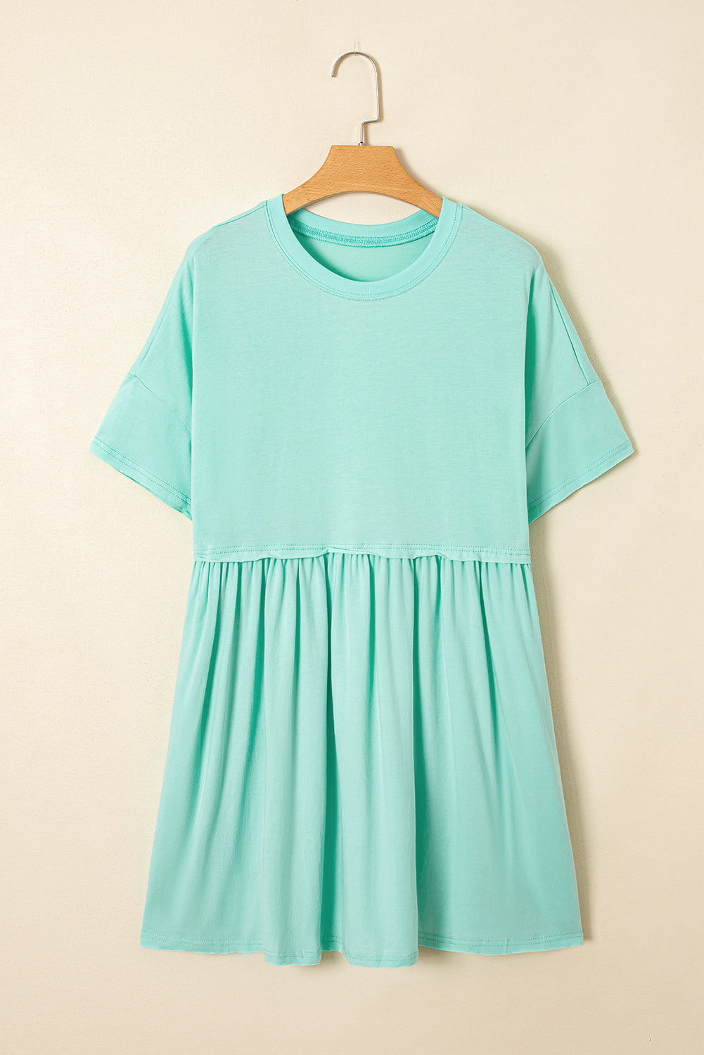 Robe babydoll unie couleur jade clair avec poches et bords effilochés