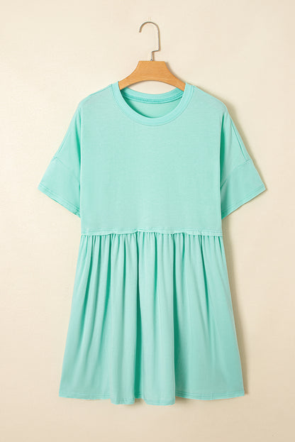 Robe babydoll unie couleur jade clair avec poches et bords effilochés